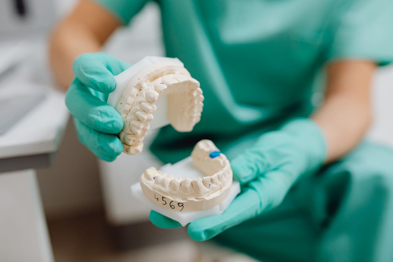 Dentist holding a dental crown cast